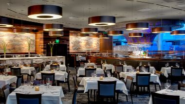 Prism Steak house at Hollywood Casino at Greektown at night with linens on the tables