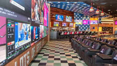 Barstool Sportsbook recliners at video wall at Greektown Casino-Hotel