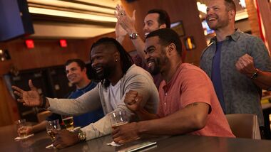 Group of guys at the Sportsbook bar cheering