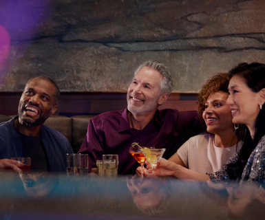 Group having drinks in booth at Prism Steakhouse