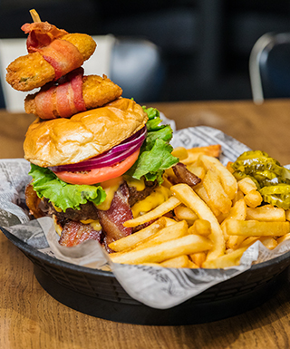 ESPN BET burger with fries and pickles