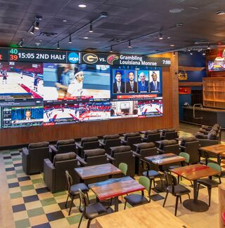 Interior picture of The Sportsbook at Hollywood Casino at Greektown, shows large video wall
