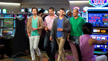 group of male friends walking through the casino