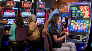 group of slot machines with couple playing